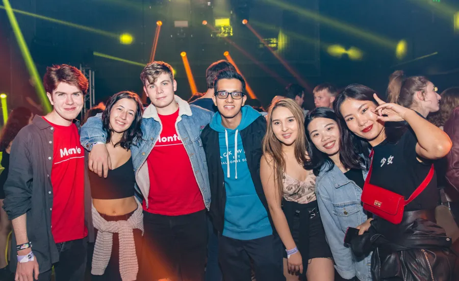 Group of happy fresher students at a nightclub.