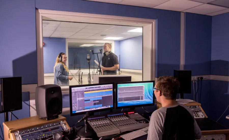 Students using the music recording suites to record a performance