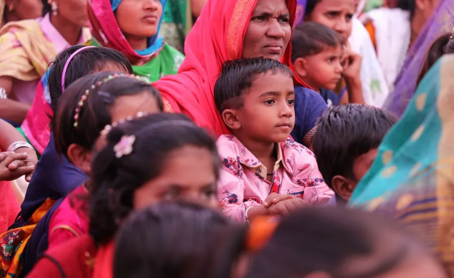 A group of Indian mothers and children in brightly coloured clothing