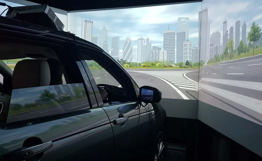 The exterior of a Land Rover driving simulator with screens showing a panoramic view