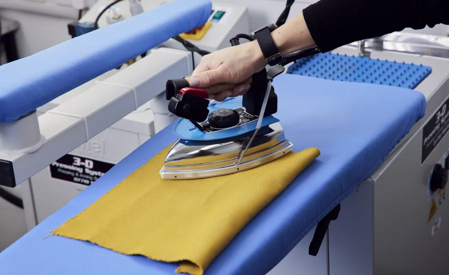 A hand using an ironing press