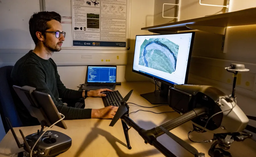 One researcher analysing geospatial data with a computer