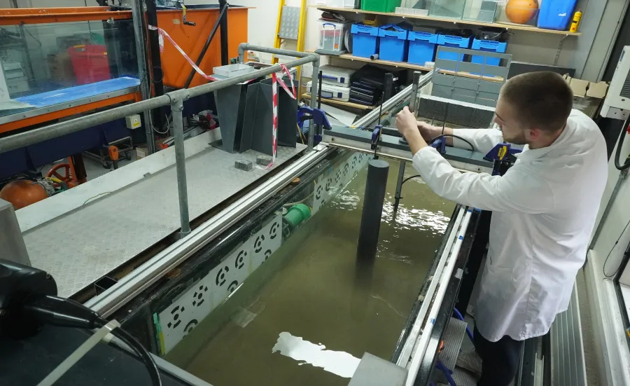 A researcher doing a flume Experiment on Scour around offshore wind turbine monopile