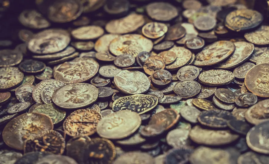 A close-up stock image of various ancient coins.