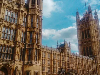 Unsplash image of the Palace of Westminster, set against a blue sky with clouds